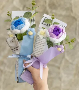 Detail of handmade crochet flower bouquet with blue and purple yarn carnations