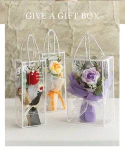 Detail of handmade crochet carnations and roses in elegant transparent gift box