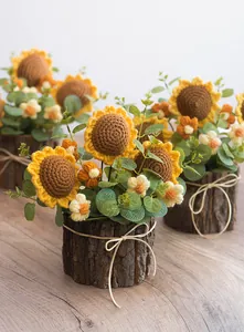 Detailed macro view of handmade crochet sunflower in a rustic textured bark plant pot