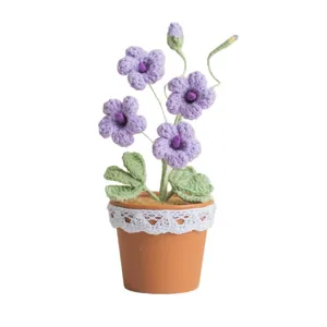 Handmade crochet freesia flower pot with purple petals and white lace detail