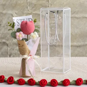 Detail of handmade crochet tulip bouquet in a clear gift box with elegant ribbon