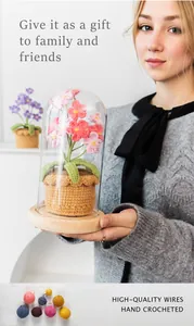 Macro detail of hand-crocheted pink flower in glass dome on a wooden base