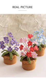 Close-up of three handmade crochet forget-me-not potted plants in purple, pink and blue
