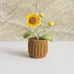Detailed close-up of a handmade crochet sunflower potted plant with soft yarn textures