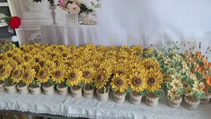 Close-up of handmade crochet sunflower in a beige pot with detailed knitted textures