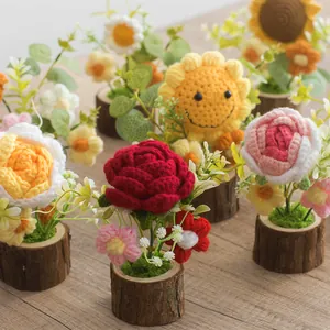 Handmade crochet sunflower and rose potted plants on a natural wooden base for decor