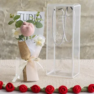 Hand-crocheted pink tulip bouquet in a clear gift box with vintage newspaper wrap