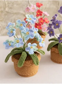 Detail of handcrafted crochet potted forget-me-not flowers in blue, red, and purple colors