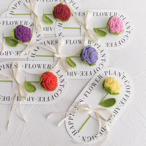 Detail of colorful hand-knitted crochet roses on decorative cards with Love ribbons