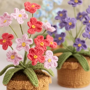 Handmade crochet forget-me-not potted flower decor in various vibrant colors