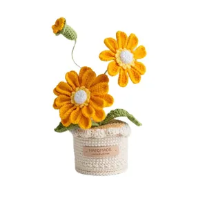 Handmade crochet zinnia potted plant with yellow petals in a woven beige base