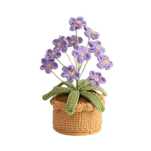 Handmade crochet purple flower potted plant on white background for home decor