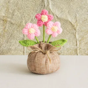 Handmade crochet puff flower potted plant with burlap bag wrapping for home decor
