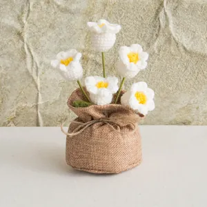 Handmade crochet lily of the valley in a rustic burlap bag with a delicate twine bow
