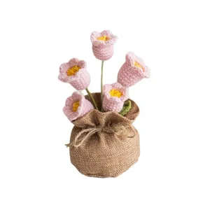 Handmade crochet pink lily of the valley flowers in a brown rustic burlap sack pot