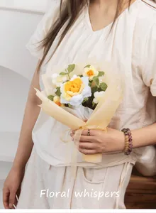 Handmade crochet flower bouquet with daisies and roses in elegant warm paper wrap