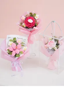 Detail of handmade crochet flower bouquet in a clear gift box with pink ribbons