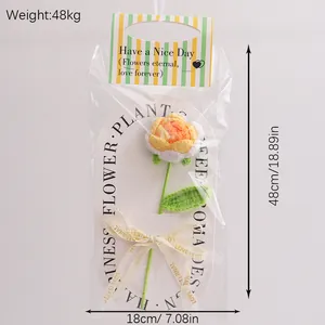Detail of handcrafted yellow crochet rose in gift wrap with ribbon and size tags