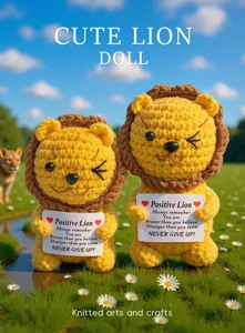 Detail of two handmade crochet lion dolls with inspirational signs in a sunny meadow