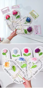 Macro detail of hand-crocheted roses in assorted colors with festive ribbon packaging