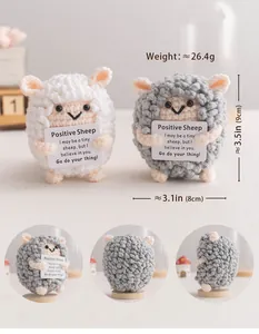Macro view of handmade crochet positive sheep plush toy showing texture and card details