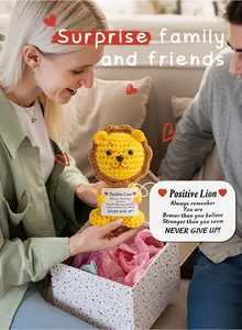 Macro shot of hand-crocheted lion doll in a gift box with a positive message card