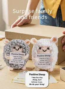 Macro detail of handmade crochet positive sheep plush with motivational quote card