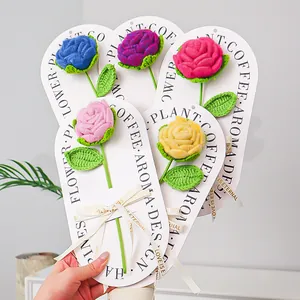 Detail of colorful handmade crochet roses with Love is Eternal ribbons for gift decoration