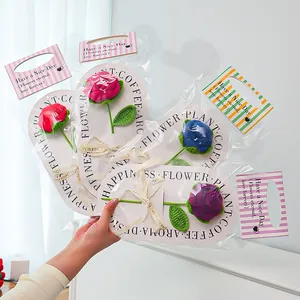 Close-up of handmade crochet roses in various colors with elegant gift packaging