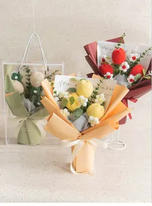 Hand-crocheted floral bouquet with tulips and daisies in a clear PVC gift bag with ribbon