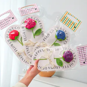 Close-up of handmade crochet roses in various colors with elegant gift packaging