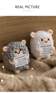 Detailed view of handmade crochet sheep set with positive encouragement cards