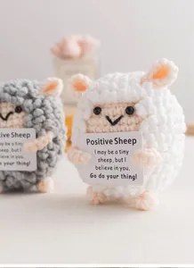 Macro detail of handmade crochet positive sheep plushies with inspirational gift cards
