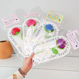 Macro view of handmade crochet roses in colorful gift bags with Have a Nice Day tags
