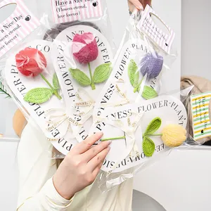 Close-up of handmade crochet tulip flowers with happiness flower plant backing cards