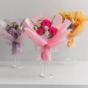 Handmade crochet flower bouquets with roses and sunflowers in elegant gift wrapping