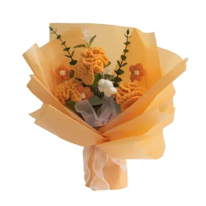 Handmade crochet flower bouquet with orange roses and sunflowers in elegant gift wrap