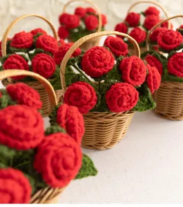 Close-up of handmade red crochet roses in a small woven basket for home decor