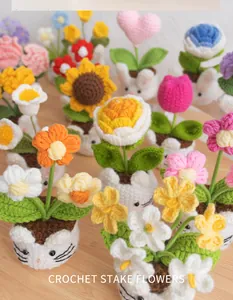 Detail of diverse handmade crochet flowers in cute cat-shaped pots for home decor