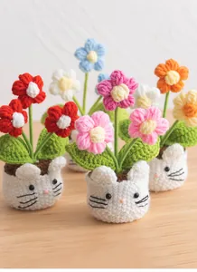 Handmade crochet forget-me-not potted plants with cute cat-shaped bases for desk decor