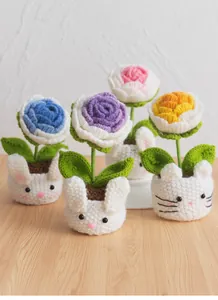 Detailed view of handmade crochet carnation flowers in cute animal-shaped yarn pots