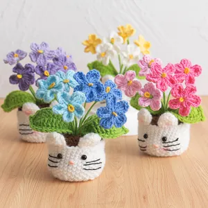 Handmade crochet forget-me-not potted plants with cute white animal-shaped bases for home decor