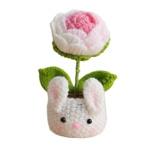 Handmade crochet pink flower pot with a cute white bunny base and knitted green leaves