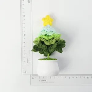 Detailed top view of a handmade crochet Christmas tree in white pot with a ruler for scale