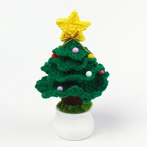 Detailed view of handcrafted crochet Christmas tree in white ceramic pot with colorful pompoms