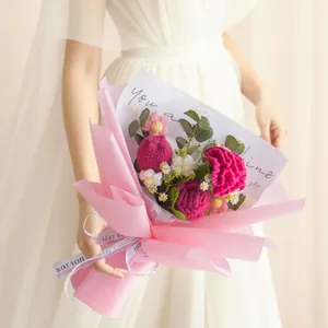Handmade crochet carnation bouquet with pink roses in frosted paper gift wrap