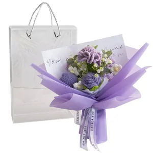 Handmade crochet carnation and rose flower bouquet in a transparent purple gift bag