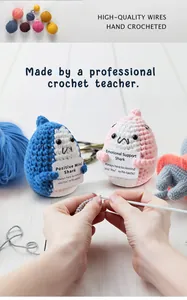Close-up of handmade crochet positive sharks with motivational cards on white wood