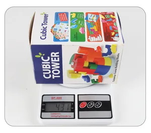 Kids cubic tower puzzle game box on scales showing 431g weight with challenge cards