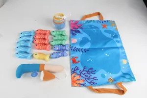 Flat lay of soft plush ocean fish toys and colorful stacking cups for baby sensory play